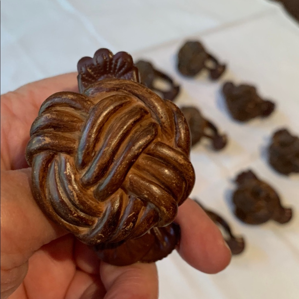 Set of 13 drapery clips or napkin rings. Nice antique bronze/brown color.